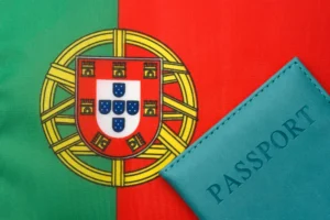 Portugal golden visa requirements concept featuring a passport and Portugal flag